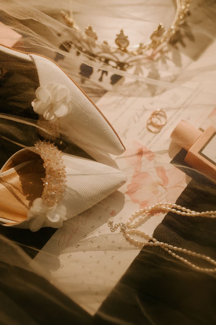 Mise en scène élégante d’accessoires de mariée — chaussures, voile, collier et serre-tête — pour inspirer votre mariage.