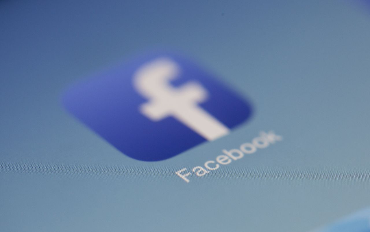 Services-01 Close-up view of the Facebook app logo on a digital screen with blurred background.